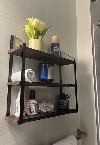 Reviewer image of side view of product with plants, towels, and toiletries on each shelf