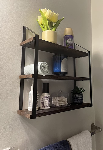 Reviewer image of side view of product with plants, towels, and toiletries on each shelf