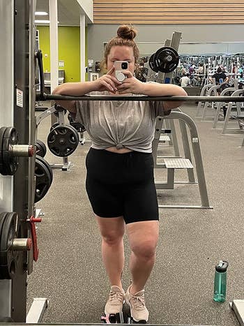 reviewer taking a picture at the gym in biker shorts