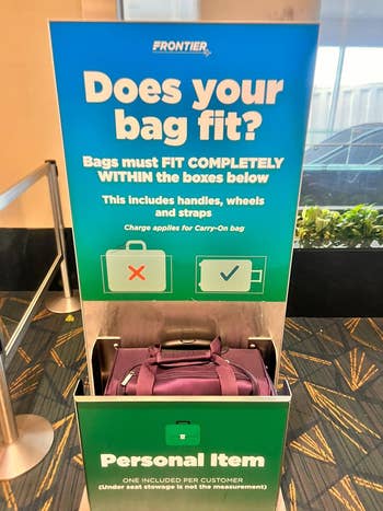 reviewer's bag in Frontier Airlines' baggage sizer for personal items