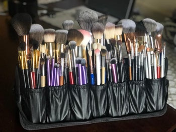 reviewer's open case, with two rows of seven pockets each, all filled with brushes