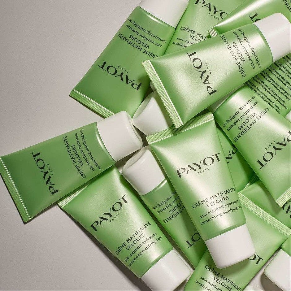 a pile of the green tubes of day cream