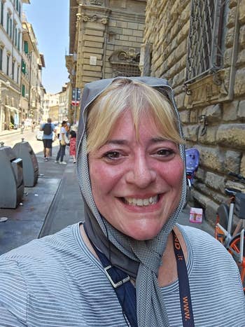 Reviewer outdoors wearing cooling towel similar a headscarf