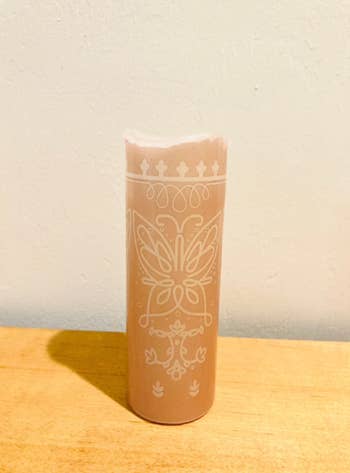 the candle with the butterfly design on it 