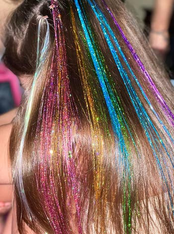 close up of same reviewers childs hair with colorful tinsel 
