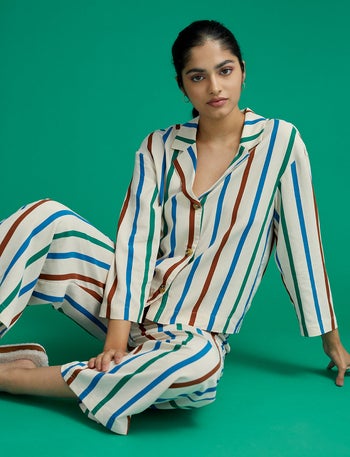 model wearing rainbow stripe longsleeve pajamas