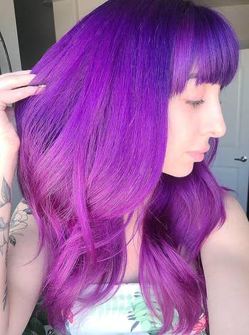 reviewer showing their hair a rich shade of purple using the dye