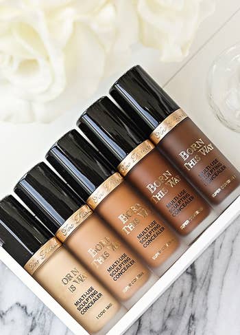 five bottles of concealer ranging from light to dark shades