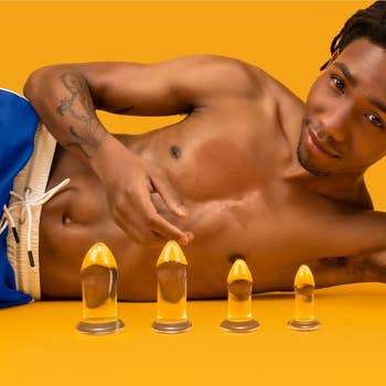 Model posing with four glass dilators of different sizes