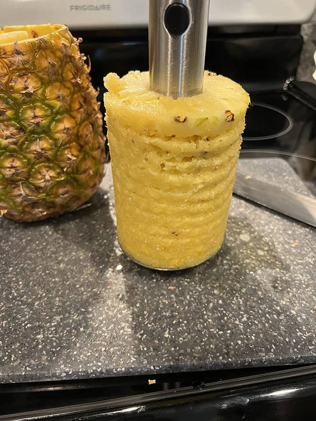 Pineapple corer instrumentality   extracting a caller  pineapple halfway   connected  a room  countertop