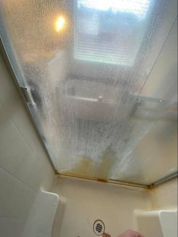 reviewer glass shower door with hard water stains making glass super foggy