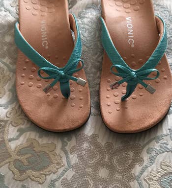 reviewer photo of the sandals in green and tan
