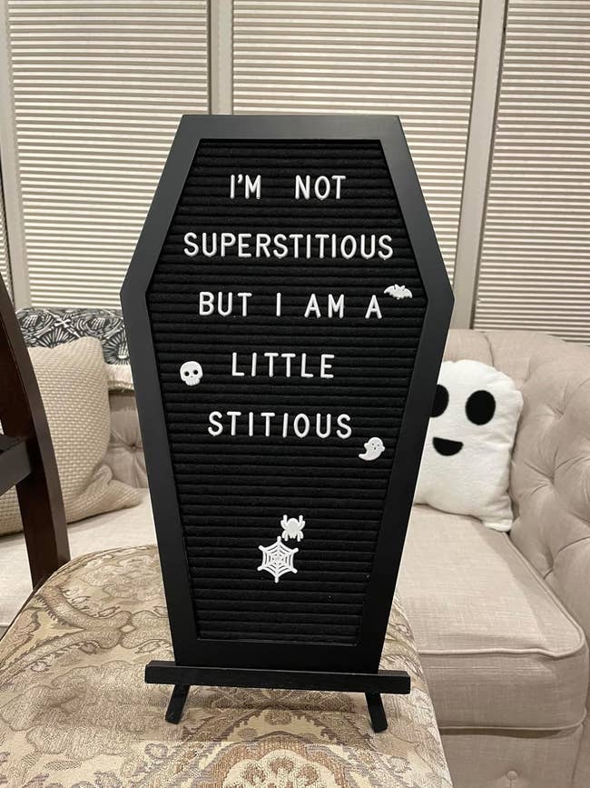 reviewer photo of a black coffin-shaped letter board that says 