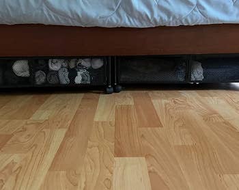 a reviewer photo of the container slid under a bed 