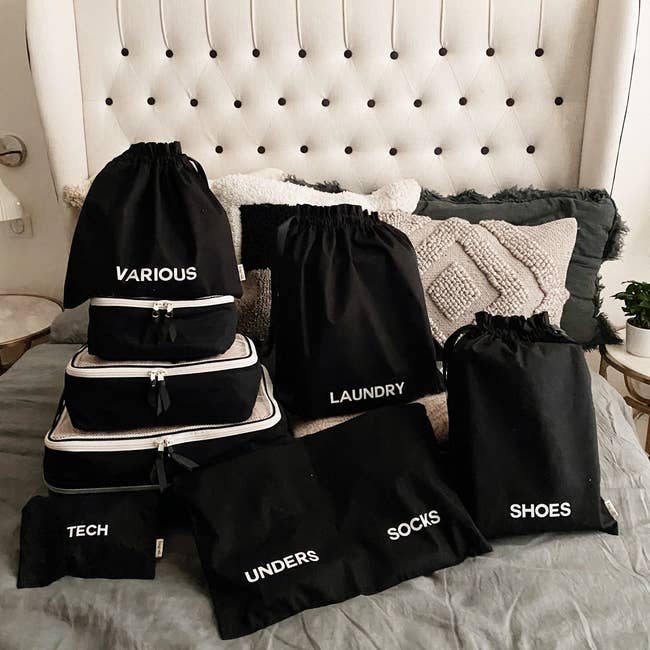 the collection of eight bags in black with different labels on each one