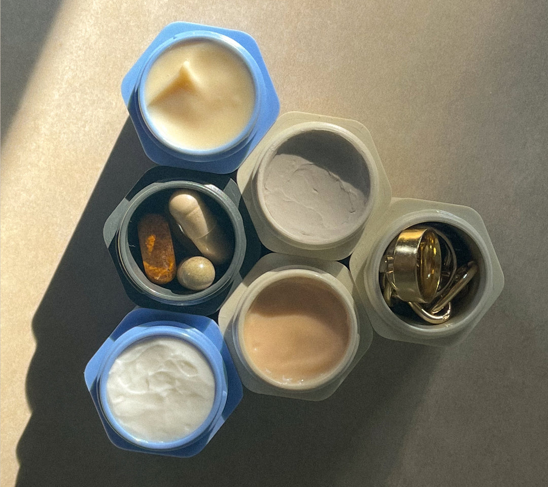 six different containers each filled with jewelry or different toiletries 