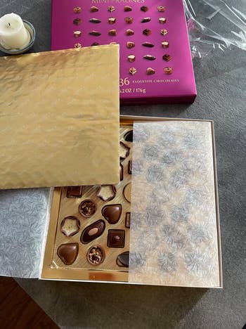 box of tiny pralines in different shapes 