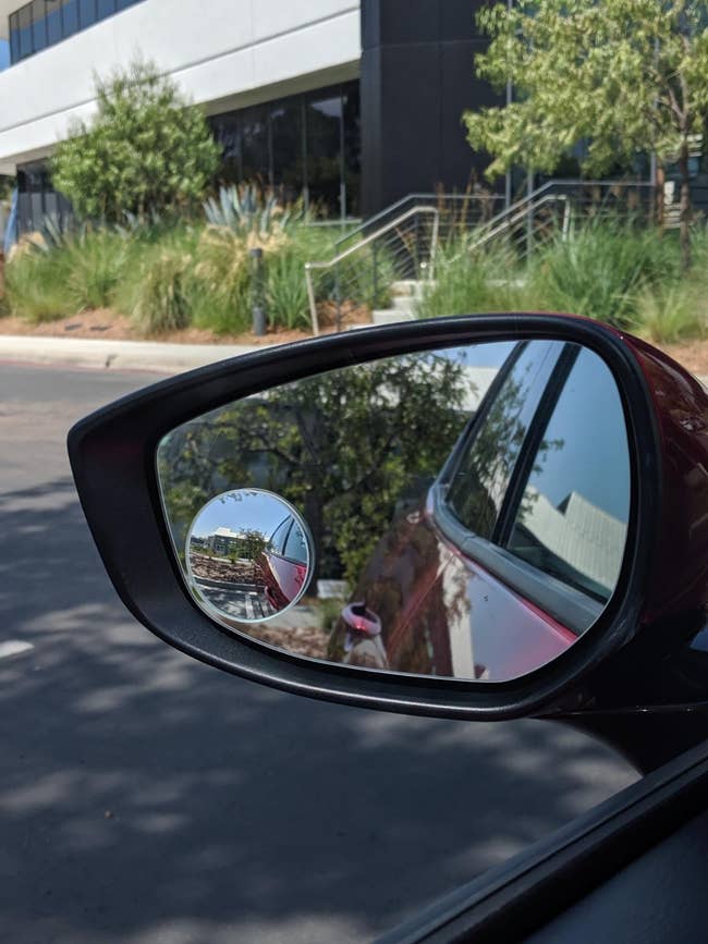 reviewer image of a round blind spot mirror on a side view mirror