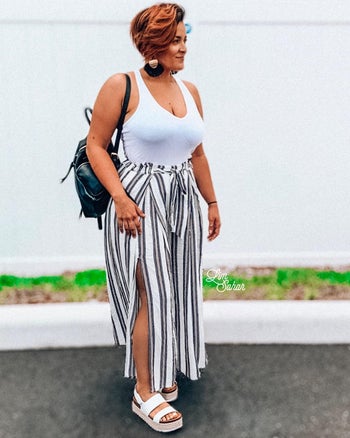 reviewer photo wearing flowy black and white stripe pants, standing outside
