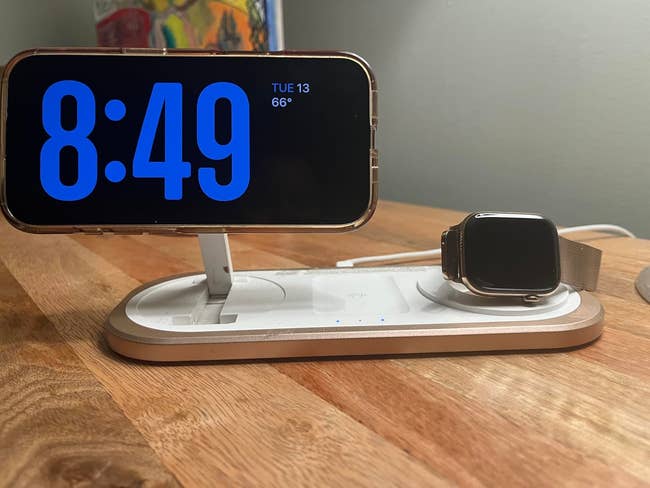 Cellphone and Apple Watch sitting connected charging pad