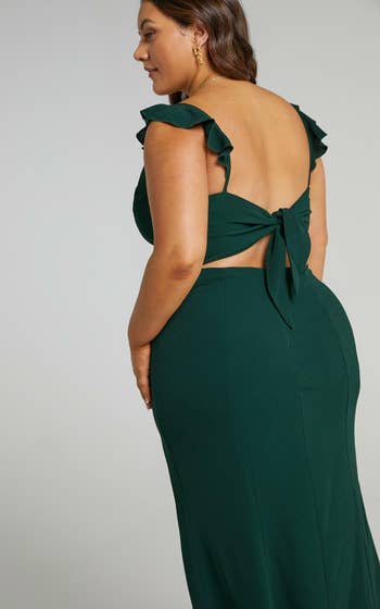 a model in the green dress showing the back tie detail