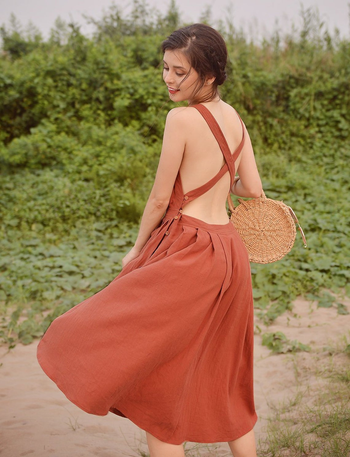 model showing off the open back with criss cross straps