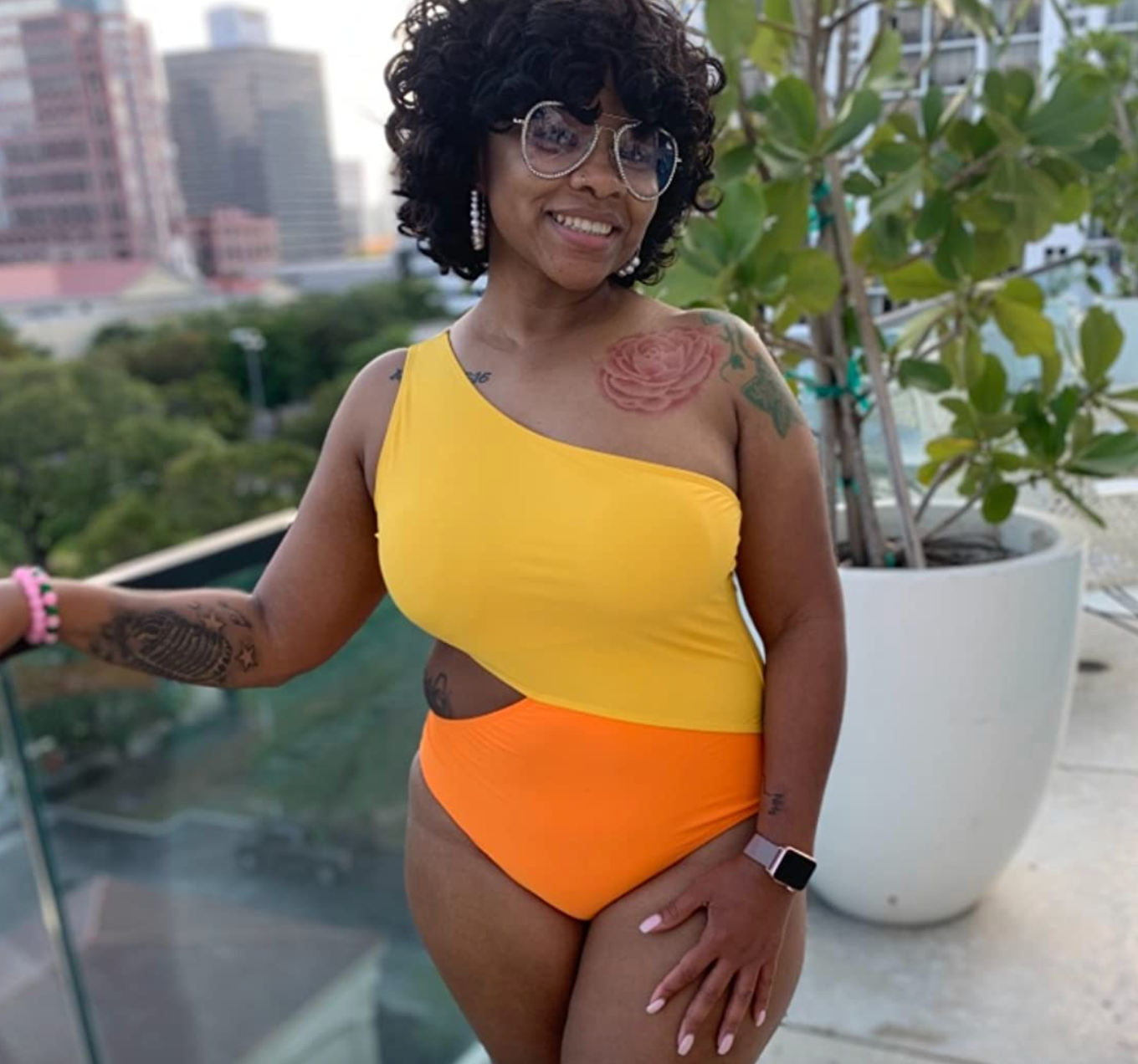 reviewer wearing orange and yellow swimsuit