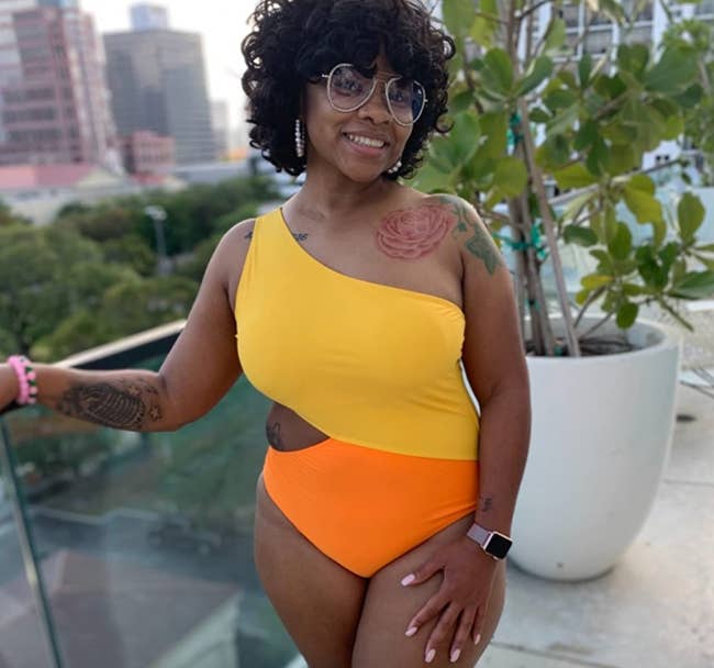 reviewer wearing orange and yellow swimsuit