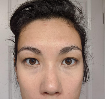 a reviewer photo of the same reviewer with the concealer applied 