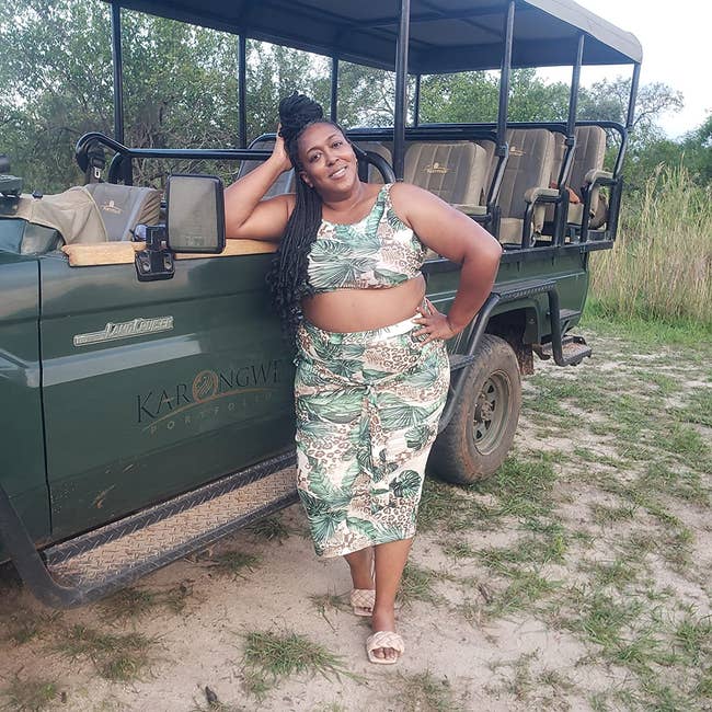 Reviewer wearing green and brown jungle skirt set on safari ride