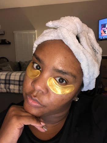 reviewer wearing gold under eye patches