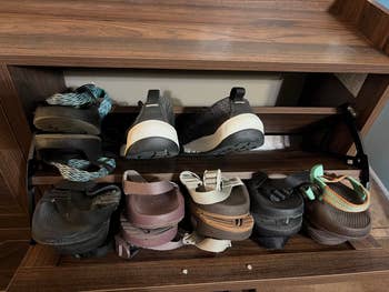 Shoes neatly arranged connected  woody  shelves, including sandals, sneakers, and slip-ons