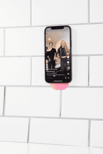 GIF of Flipstik sticking a phone to the wall