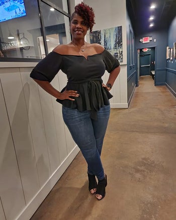 a reviewer wearing the top in black