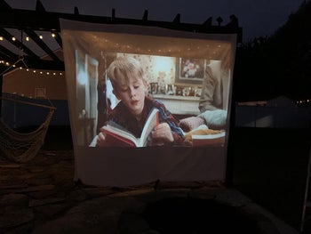 a reviewer photo of a projected movie displaying on a sheet