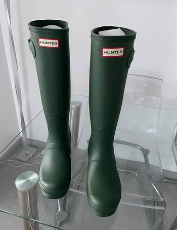 a reviewer showing their boots in hunter green