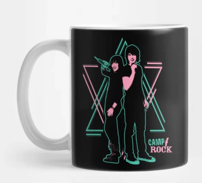 black mug with a turquoise and pink print of mitchie and shane and the words camp rock in the bottom right