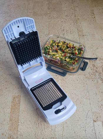Vegetable chopper adjacent  to a instrumentality  of diced effect   and vegetables, showcasing its relation  for nutrient  preparation