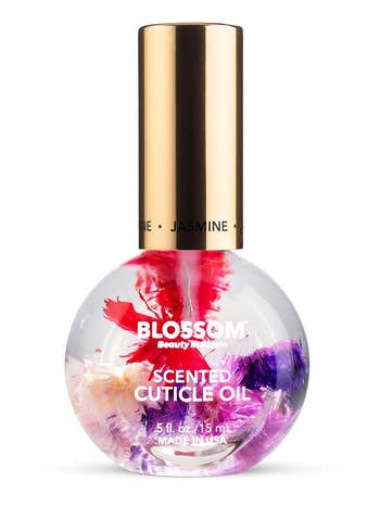 A bottle of Blossom scented cuticle oil infused with real flowers, labeled for nail care