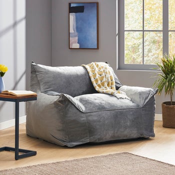 a gray velvety bean bag chair