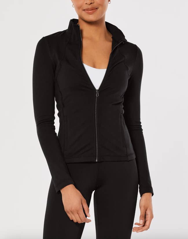 Model in a zip up compressive black jacket 