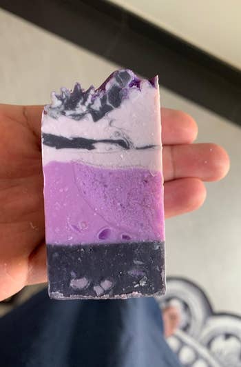 a reviewer holds purple soap