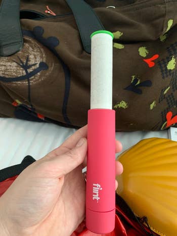 Reviewer holding their pink portable roller showing the sticky area