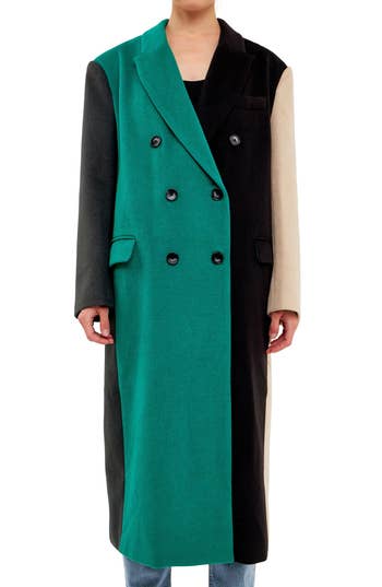 model in long double breasted coat in green black and tan