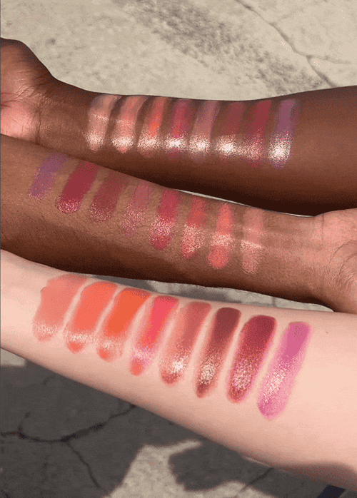 Three models of different skin tones with swatches of the blushes on their arms 