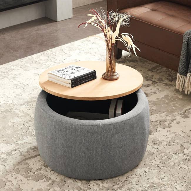 upholstered storage table with a wooden top
