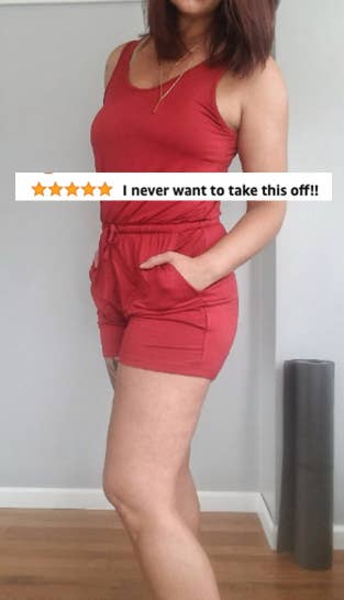 reviewer wearing one piece in red with text on top saying 
