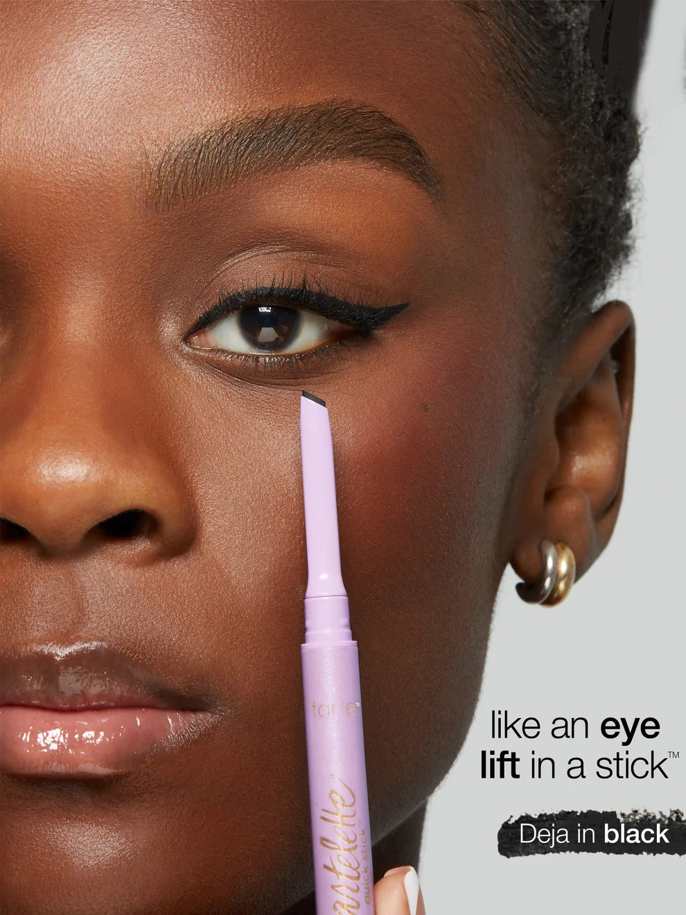 Close-up of a idiosyncratic   applying Tarte's Deja Vu eyeliner successful  black