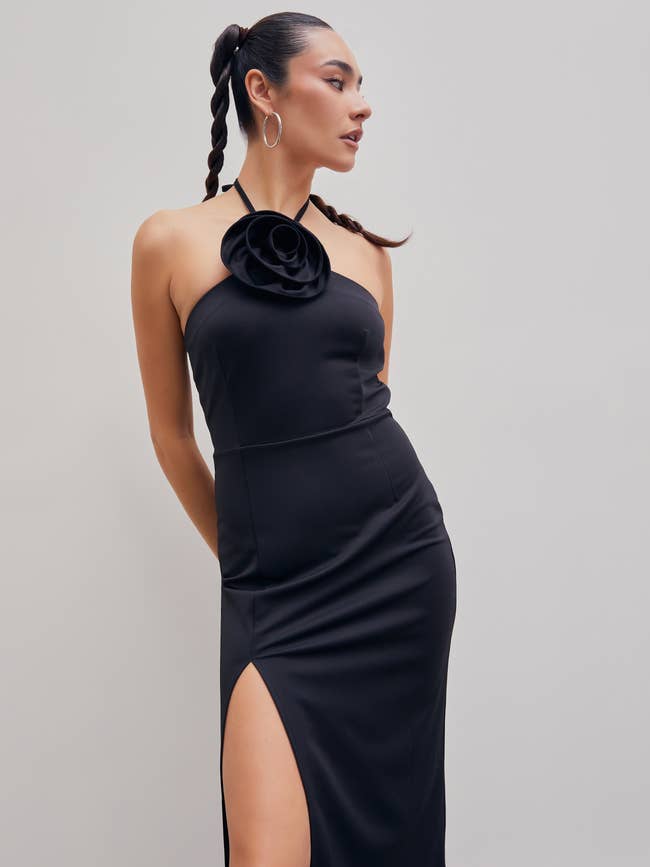 A model posing in the black dress