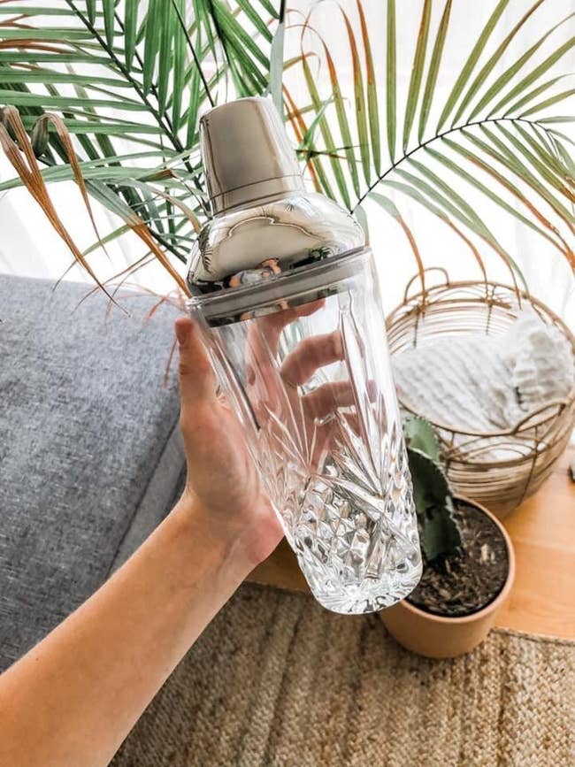 Reviewer holds the wide   and stainless alloy  cocktail shaker
